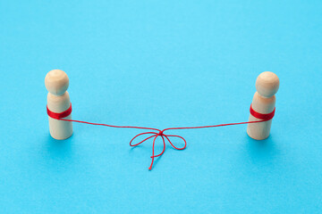 Love in the distance. Two figures of people connected by a thread, best friends forever.