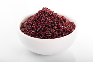 Sumac. Sumac spice in white bowl, on white background. Sumac, sumac flakes