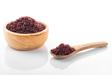 Sumac. Sumac spice in wooden bowl, on white background. Sumac, sumac flakes