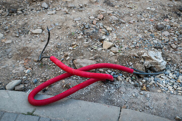 Electrical cable sticks out of the ground.