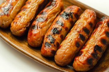 Grilled classic British sausage made from prime cuts of pork on the wooden plate