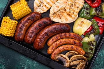 Grilled sausages, meat, and vegetables.