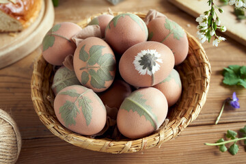 Preparation of Easter eggs for dying with onion peels, decorated with leaves