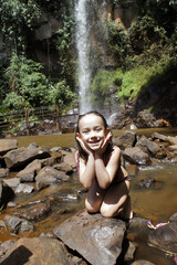 Little girl playing at the waterfall in Brotas, rural area of ​​São Paulo Brazil.