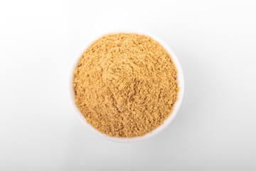 Ginger powder. Ginger powder in white bowl, on white background. Ginger, ginger powder.