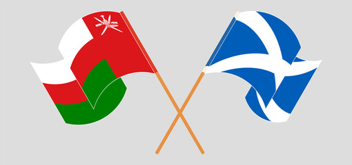 Crossed and waving flags of Oman and Scotland
