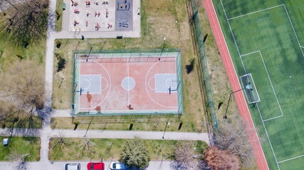 Aerial view of public basketball court near the playground. 