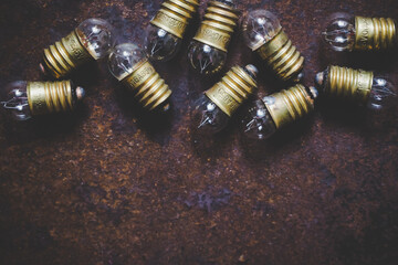 Incandescent light bulbs on rough metal surface, top view, background - 426193442