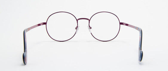 Transparent round glasses on a white background