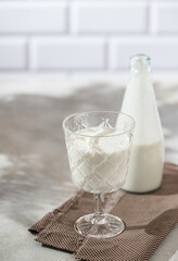 Fermented drink kefir, yogurt in a glass jar on a light background. Probiotic cold fermented dairy drink. Healthy gut flora concept.