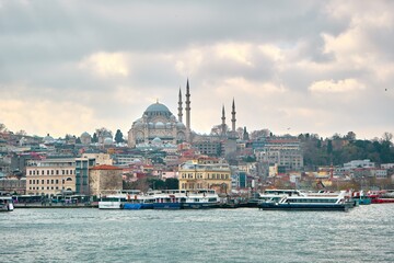Turkey istanbul 03.03.2021. old and ancient ottoman mosques Yeni Cami mosque in istanbul turkey during morning by taken photo from istanbul bosporus.
