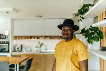 Portrait of a charming african american man at home, in the kitchen.