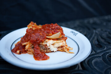 Homemade cheesy lasagne on a white plate