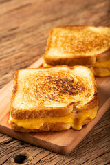Grilled ham and cheese. Sandwich with cheese and ham on grill.