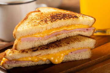 Grilled ham and cheese. Sandwich with cheese and ham on grill.