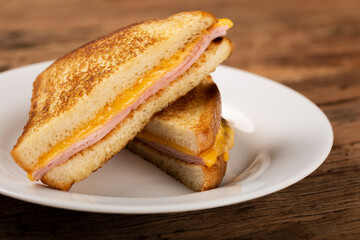 Grilled ham and cheese. Sandwich with cheese and ham on grill.