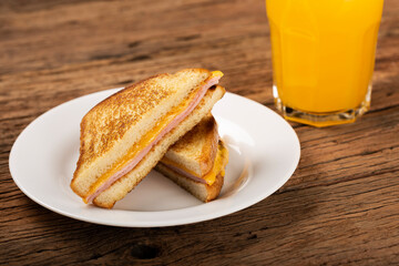 Grilled ham and cheese. Sandwich with cheese and ham on grill.