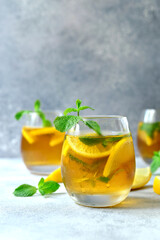 Delicious iced tea with lemon and mint in a glasses.