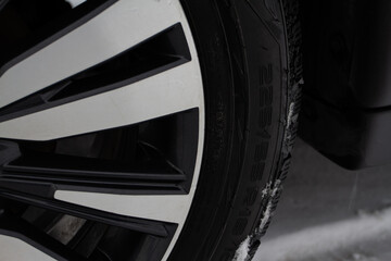 Close up view of tire with tire width, height and wheel diameter designation. Tire size types...