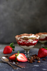 Tiramisu - traditional italian dessert from mascarpone, biscuit and coffee with fresh strawberry.
