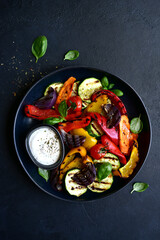 Grilled vegetables with yogurt sauce. Top view with copy space.