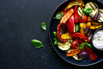 Grilled vegetables with yogurt sauce. Top view with copy space.
