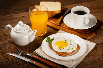 Fototapeta na wymiar Breakfast with juice, coffee and toast with fried egg.