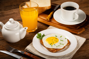 Breakfast with juice, coffee and toast with fried egg.