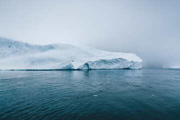 Arctic nature landscape with icebergs in Greenland icefjord with midnight sun sunset sunrise in the...