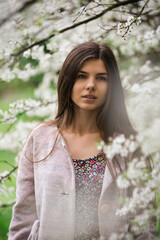 Naklejka premium Nice girl in blossom cherry tree