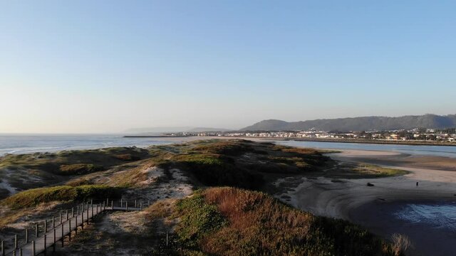 DRONE AERIAL FOOTAGE: Northern Litoral Natural Park in Ofir, Fao, Esposende, Portugal at sunset. The two sides of Restinga de Ofir. One facing the ocean, the other the estuary of C&aacute;vado River.