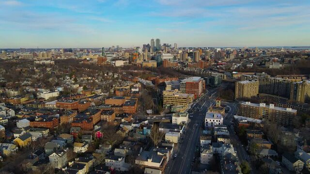 Brookline village commercial center at Harvard Street and Washington Street aerial view with Boston Back Bay skyline at the background in winter in town of Brookline, Massachusetts MA, USA. 