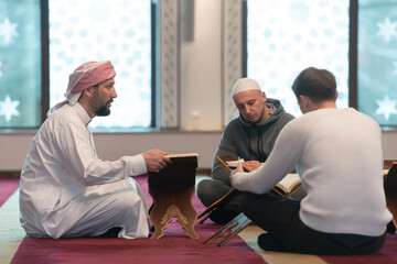 muslim people in mosque reading quran together
