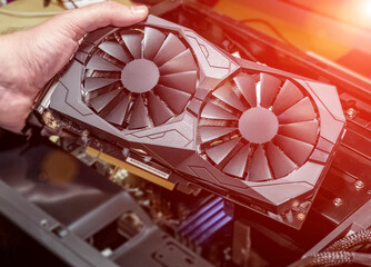 Installing video card in an open case of personal computer. Graphics adapter or graphics card in...
