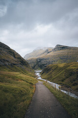 River delta with black sand beach, rocks and high cliffs in Faroe islands, close to village Saksun...