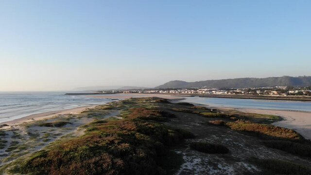 DRONE AERIAL FOOTAGE: Northern Litoral Natural Park in Ofir, Fao, Esposende, Portugal at sunset. The two sides of Restinga de Ofir. One facing the ocean, the other the estuary of C&aacute;vado River.