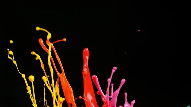 Colorful splashing paint in super slow motion.