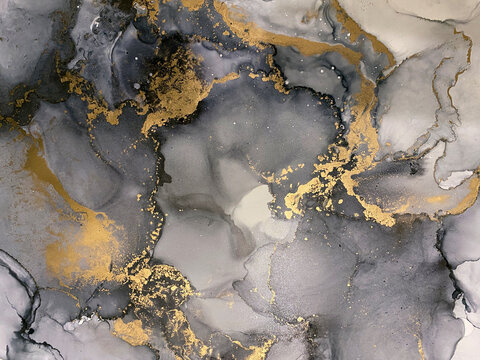 Abstract grey art with gold — black and white background with beautiful smudges and stains made with alcohol ink and golden pigment. Fluid art texture resembles watercolor or aquarelle. © Luvricon