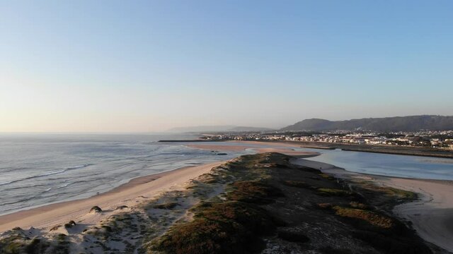 DRONE AERIAL FOOTAGE: Northern Litoral Natural Park in Ofir, Fao, Esposende, Portugal at sunset. The two sides of Restinga de Ofir. One facing the ocean, the other the estuary of C&aacute;vado River.
