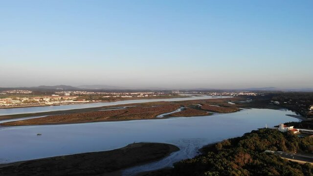 DRONE AERIAL FOOTAGE - The Northern Litoral Natural Park in Ofir, Esposende, Portugal. The Cavado River estuary at sunset.