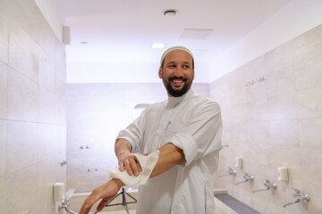 a portrait of a man in abdesthana using a towel