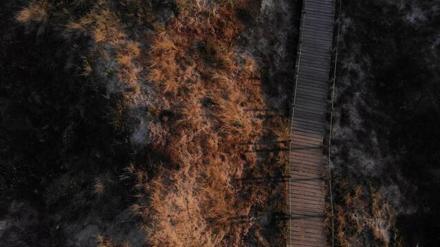 DRONE AERIAL FOOTAGE: The Northern Litoral Natural Park in Ofir, Esposende, Portugal. Wooden boardwalk and the Ofir Towers in the background. Sea, beach boulders, pebble shore and waves at sunset.