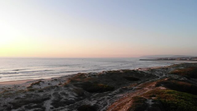 DRONE AERIAL FOOTAGE: Northern Litoral Natural Park in Ofir, Fao, Esposende, Portugal at sunset. The two sides of Restinga de Ofir. One facing the ocean, the other the estuary of C&aacute;vado River.