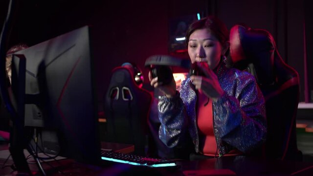 Frustrated girl gamer loses the game, removes the headset and leaves the playing area
