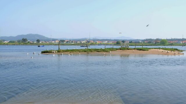 Fao, Esposende, Portugal - April  3, 2021: The Cavado River estuary on a sunny day. Word FAO made of stone concrete letters.