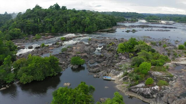 DRONE IMAGE NATURE AMAZON RIVER OIAPOQUE WATERFALLS DIVISION BETWEEN BRAZIL AND FRENCH GUIANA BOAT IN FLOREST
