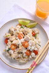 Fried rice with tofu, mung bean sprouts and tomato on dish eating with orange juice, Asian healthy vegan food