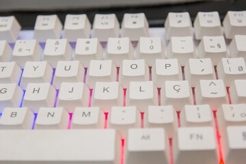 white gamer keyboard with colorful lights in rio de janeiro.