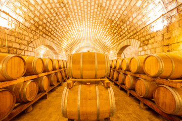  Wine Cellar with Wooden Barrels, Wine barrels stacked in the cellar of the winery