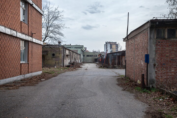 Abandoned factories and warehouses in red brick, with broken windows and crumbling walls in Eastern Europe, in Pancevo, Serbia, former Yugoslavia, during a cold winter afternoon 